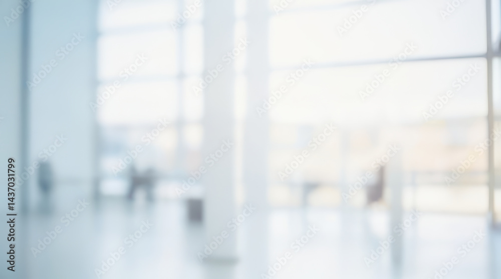 Blurred interior view of a bright modern building with large windows and columns. Blurred interior view of a bright modern building with large windows and columns.
