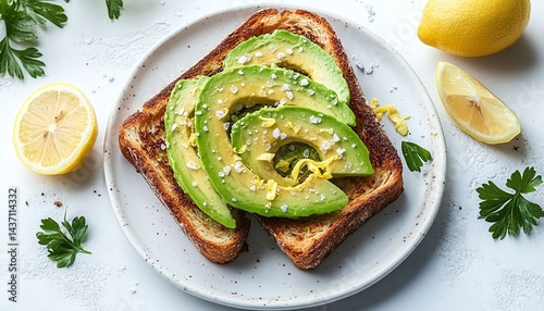 Delicious toast topped with sliced avocado, lemon zest, and sea salt.