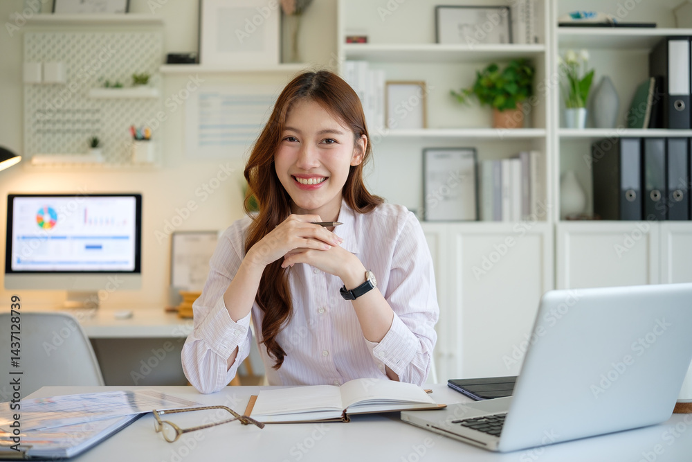 Female entrepreneur posing confidently at modern workspace. Female entrepreneur posing confidently at modern workspace.