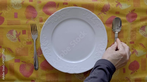 Table Setting With Plate and Cutlery on Vibrant Tablecloth