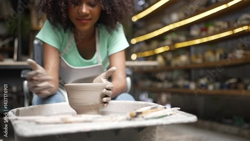 African woman make earth ware at workshop. Small business, hobbies.