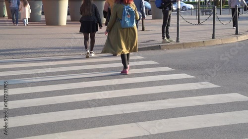 Slow motion dynamic video of people crossing crosswalk for pedestrians close up in busy city day