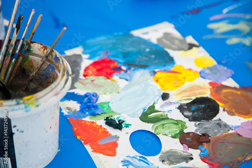 Coloured paint and painting brushes for children's art class