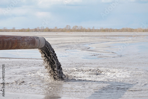 Pollution of the environment by industrial outfalls. Flow of dirty water flows out of the pipe.