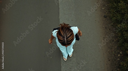 Minimalistic Top-View of a Young Woman Walking on a Smooth Surface — Solitude, choice, Freedom and Modern Urban Lifestyle Concepts