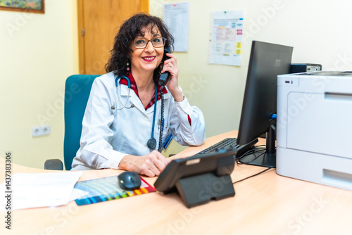 Obraz na płótnie Female doctor answering phone call in nursing home office w salonie