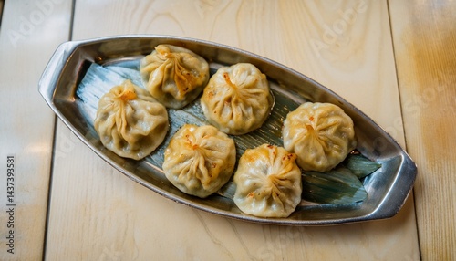 Freshly steamed momos served with spicy chutney. A popular Asian street food and delicious dumpling snack from Tibetan, Nepali, and Indian cuisines.