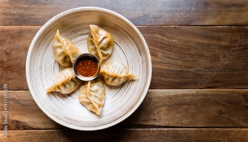 Freshly steamed momos served with spicy chutney. A popular Asian street food and delicious dumpling snack from Tibetan, Nepali, and Indian cuisines.