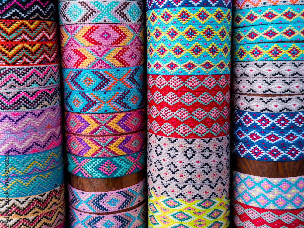 Colorful patterned textile rolls with traditional geometric designs Colorful patterned textile rolls with traditional geometric designs