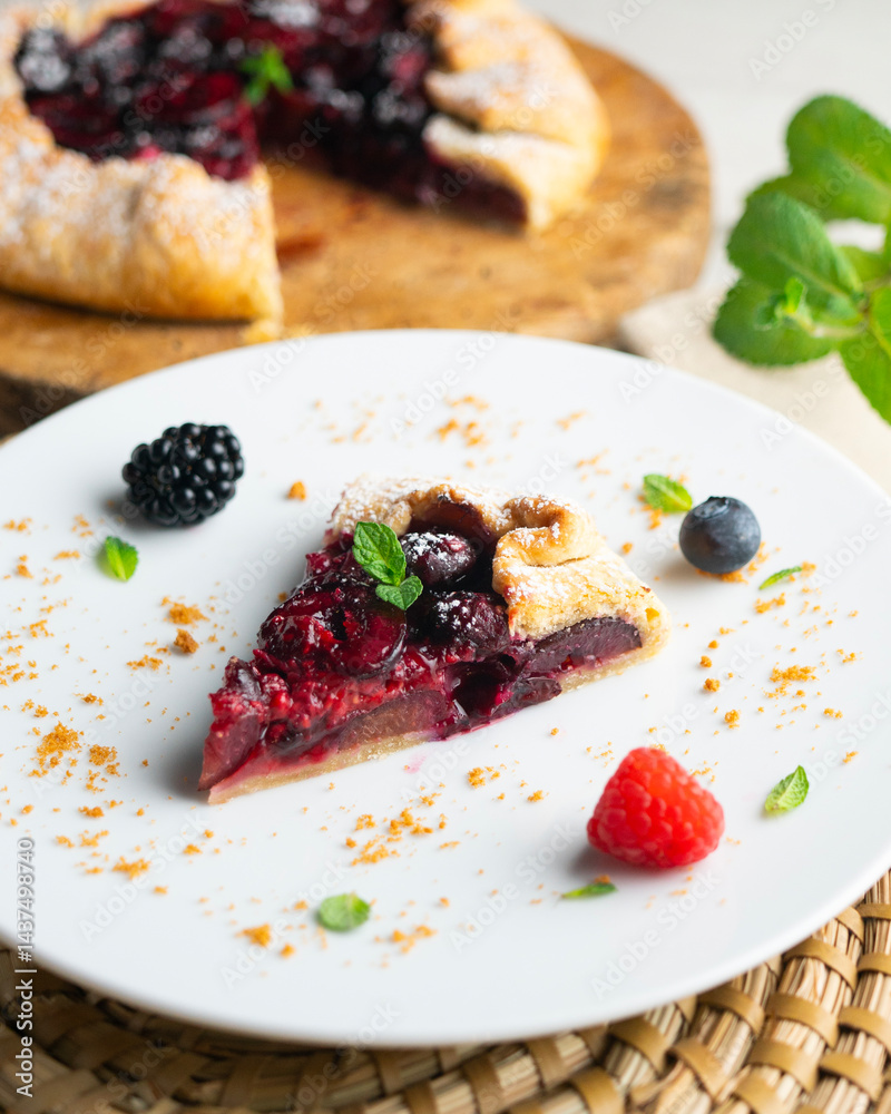 Galette tart with red berries, cherries, raspberries and blackberries. Top view table with christmas decoration. Galette tart with red berries, cherries, raspberries and blackberries. Top view table with christmas decoration.