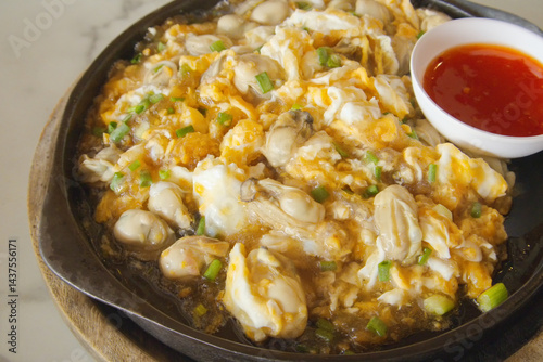 Sizzling Thai Oyster Omelette on Hot Plate. Fresh Oysters, Fluffy Eggs & Crispy Bean Sprouts. Thai Street Food Classic