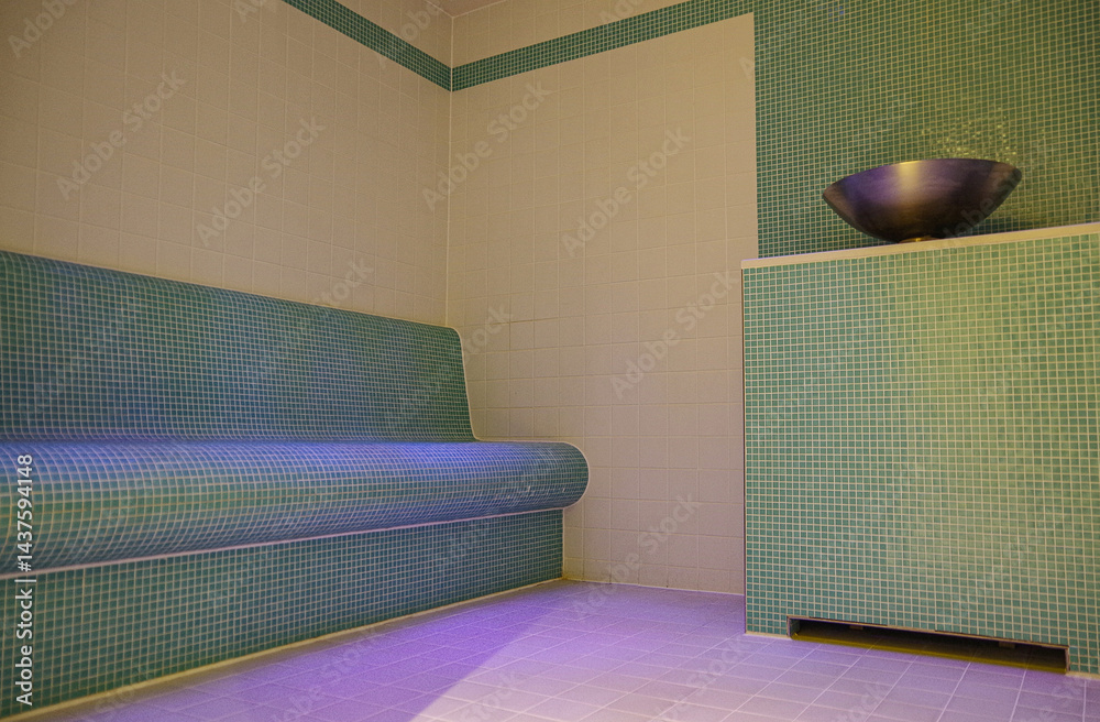 Thermal suite with heated loungers in mosaic tile design or relaxation chairs in spa or wellness area on modern luxury cruiseship or cruise ship liner in clean modern design