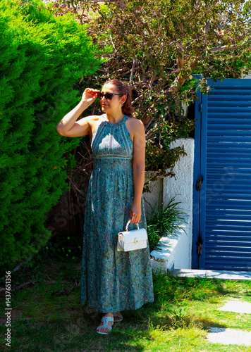 portrait of beautiful young woman in sunglasses in the garden	