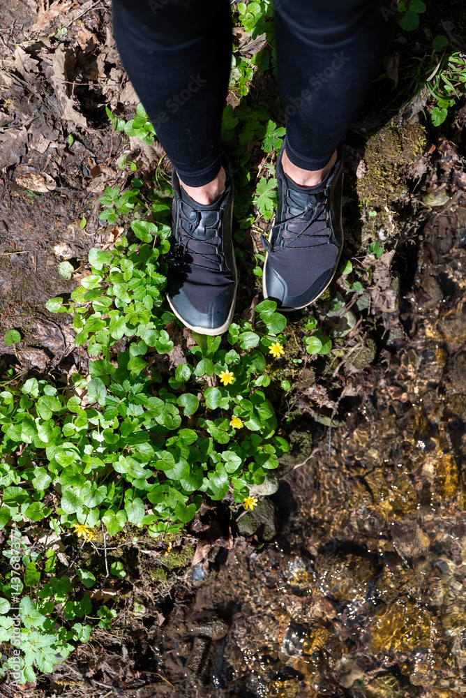 Woman legs with barefoot hiking shoes in the summer mountain Woman legs with barefoot hiking shoes in the summer mountain