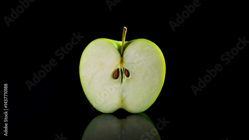 Eine einzelne perfekt geformte grüne Apfelhälfte auf einem schwarzen Hintergrund