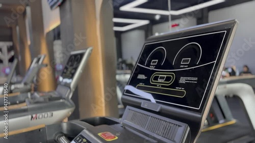 View of treadmills lined up in a modern gym, offering a diverse range of exercise options to enhance overall well-being and promote a healthy lifestyle, sports training and cardio workout.