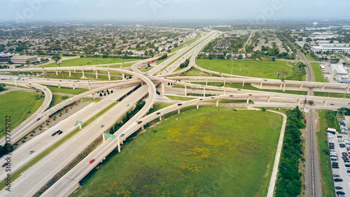 Dallas master planned mixed used residential houses, apartment complex, hotels near multilevel stack interchange road junction, highway bridge Dallas North Tollway, President George Bush Turnpike