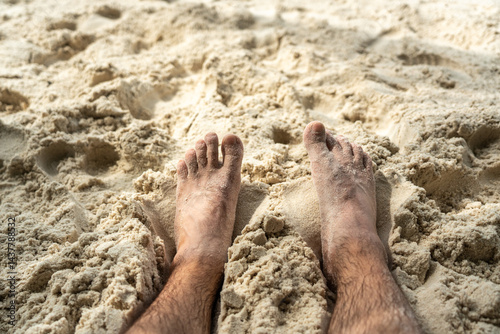 Obraz na płótnie Bare feet resting in warm sand on tropical beach, symbolizing summer relaxation, freedom w salonie