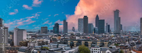 Obraz na płótnie Aerial view of Frankfurt, Germany, featuring modern skyscrapers, traditional architecture, and the Hauptbahnhof under a vibrant sunset sky. w salonie
