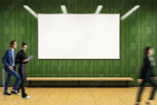 Fototapeta Naklejka Na Ścianę i Meble -  Blank billboard on green tiled wall with blurred business people walking by in modern subway station interior under bright lights, creative design background.
