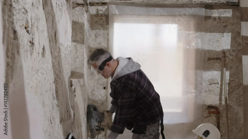 Construction builder worker on site wearing safety helmet and headphone, tapping hard hat with fist, showing confidence and protection, emphasizing safety first and personal protective equipment, PPE
