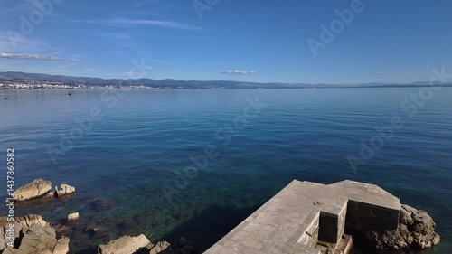 Wallpaper Mural Amazing view from the Lungomare Coastal Promenade near Lovran, Croatia. Rocky coastline of the Adriatic Sea with Rijeka in the background. The famous seaside promenade is more then 100 years old. Torontodigital.ca