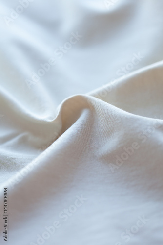 A serene close-up of soft, flowing fabric, capturing gentle curves and subtle textures in a calming, light-filled setting.