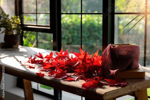 Autumn leaves on wooden table near window photo