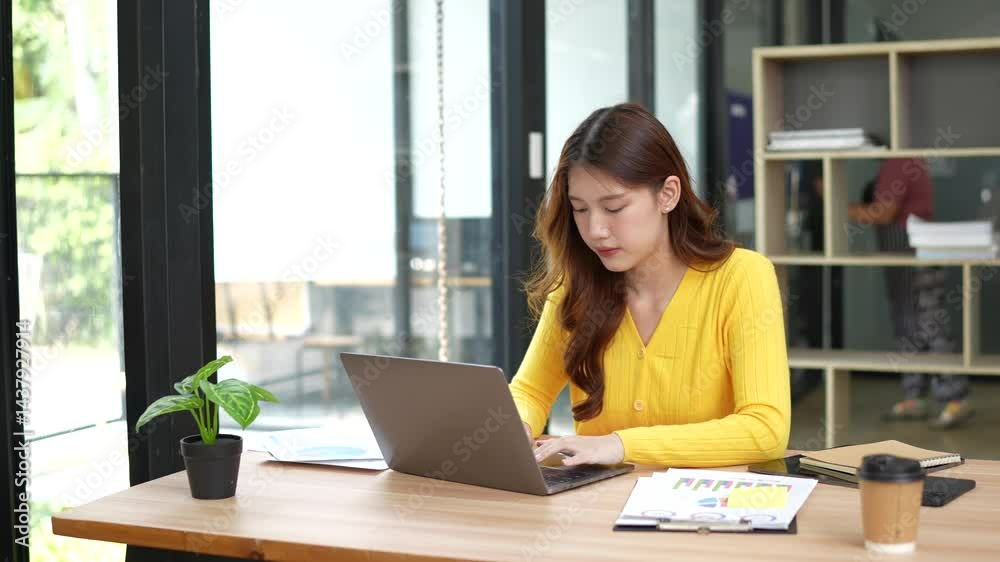 Businesswoman angry stressed about digital investment and doing money market research using laptop in office Businesswoman angry stressed about digital investment and doing money market research using laptop in office
