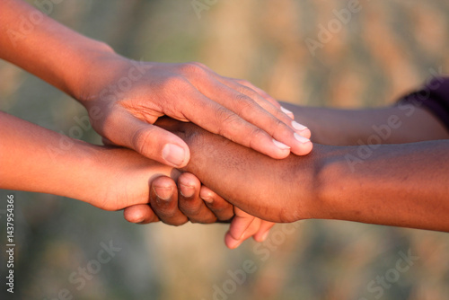 Many people's hands together and a blurred background
