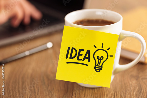 Obraz na płótnie Coffee cup with yellow sticky note showing idea and lightbulb symbol on wooden desk workplace creativity productivity business startup goal planning innovation motivation w salonie