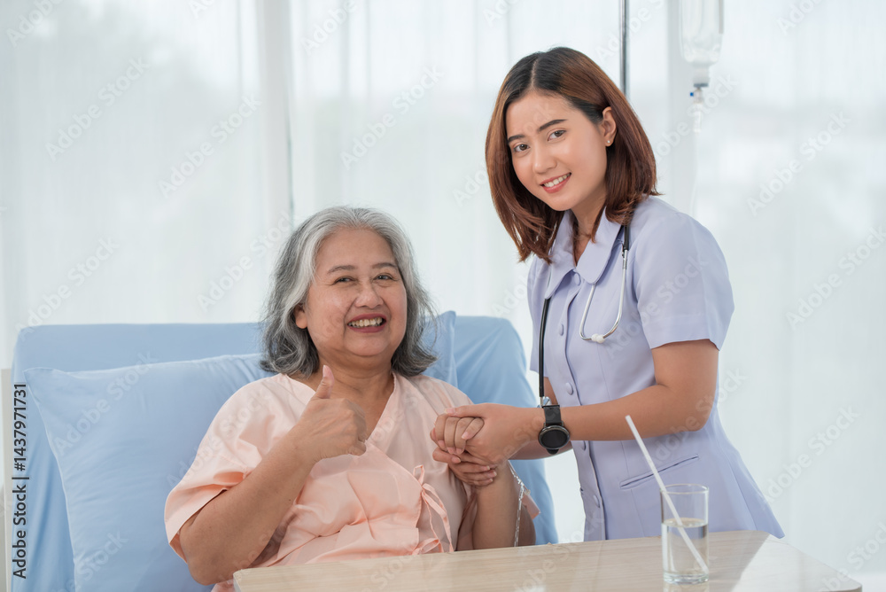 Obraz premium Smiling caring Asian doctor supporting holding hand of olde senior female patient at clinic or hospital
