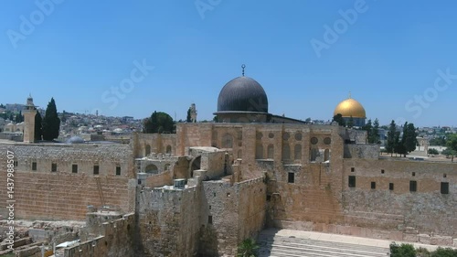 Southern Wall of Temple Mount and dome of the rock, Aerial

Ancient view of the Southern Wall and Al-Aqsa Mosque in the Old City of Jerusalem, featuring historic ruins, stone steps