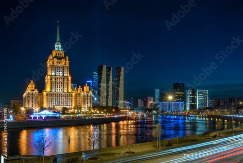 Obraz na płótnie Night view of high-rise stalinist building and Moscow river with Moscow City buildings in the background in Moscow, Russia. w salonie