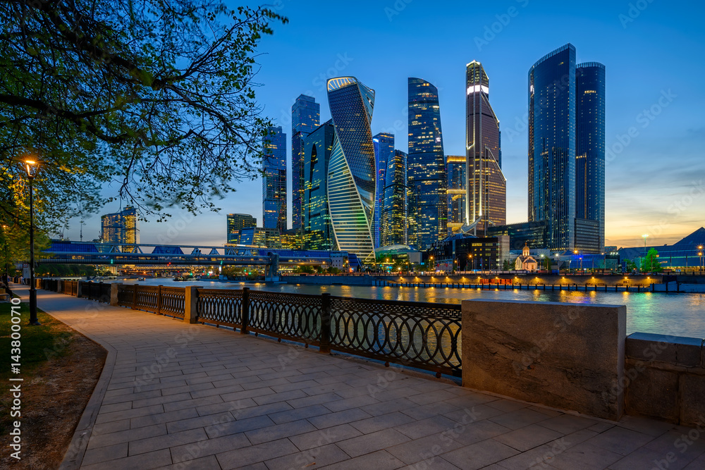 Night view of skyscrapers of Moscow City business center, Moscow river and embankment in Moscow, Russia. Architecture and landmark.