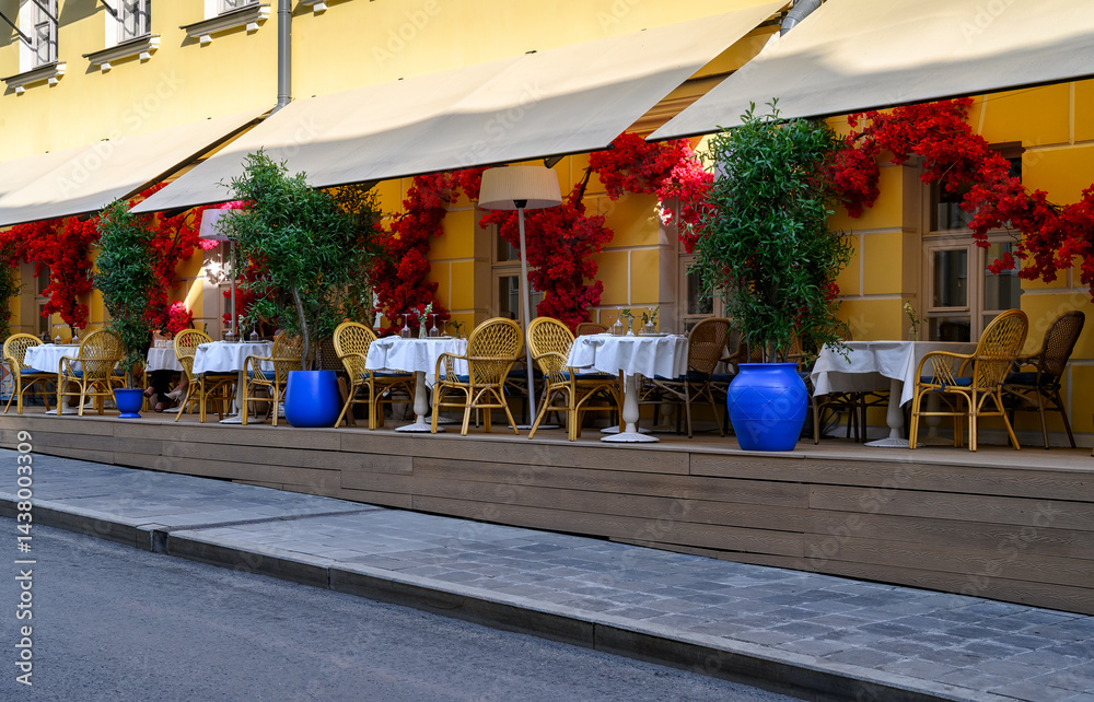 Cozy street with tables of restaurant in center of Moscow, Russia. Cityscape in Moscow. Architecture and landmarks of Moscow.