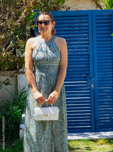 portrait of beautiful young woman in sunglasses in the garden