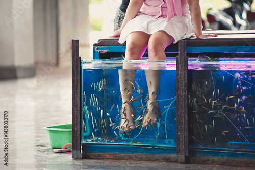 Feet in Fish Spa Tank – Garra Rufa Fish Pedicure Treatment at Wellness Center.