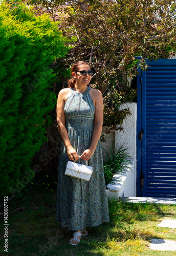 portrait of beautiful young woman in sunglasses in the garden