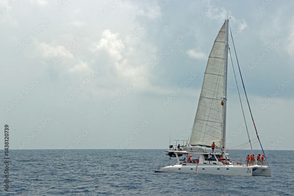 Naklejka premium Catamaran Sailing Adventure on the Open Sea 