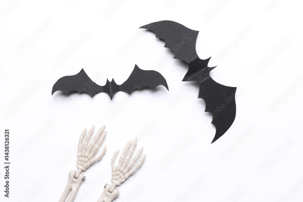 Fototapeta premium Bats and skeleton hands on white background. Halloween background