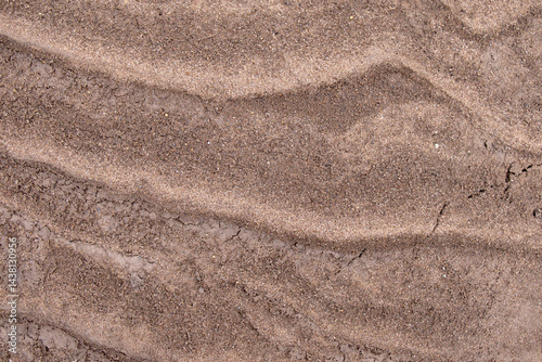Fotografie Sandy dark brown background, texture