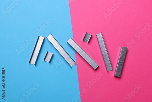 Canvas Print Staples for construction stapler on pink blue background
