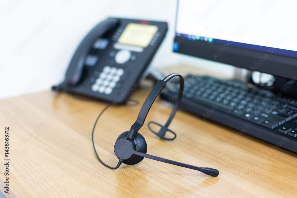 VOIP headset for callcenter on desk at customer service office. Communication support for sale support and telemaketing Helpdeskac