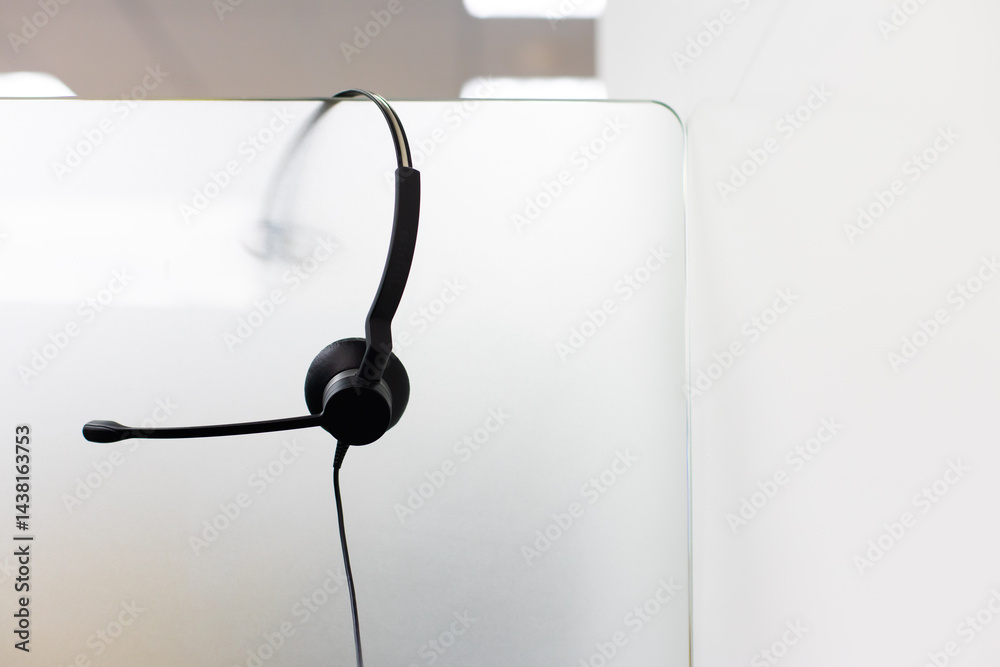 VOIP headset for callcenter on desk at customer service office. Communication support for sale support and telemaketing Helpdeskac