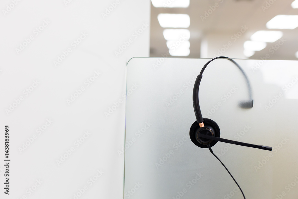 VOIP headset for callcenter on desk at customer service office. Communication support for sale support and telemaketing Helpdeskac
