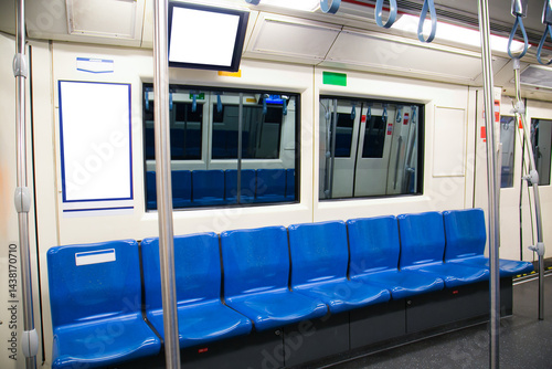 Blue seats and grab bars in electric trains