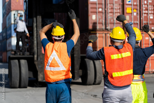 Strike of workers in container yard. Group of multiethnic engineer people during a protest in workplace