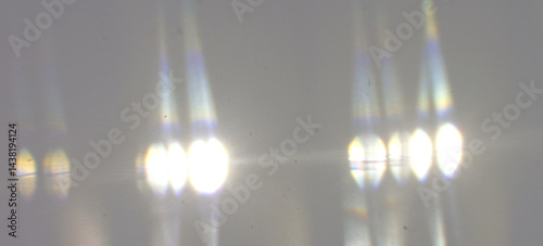 Vertical bands of bright light with sharp vibrant rainbow refractions along their edges on transparent background