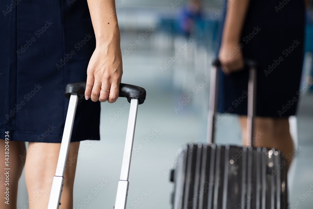Closeup hand woman Walking in airport. Cabin crew, air hostess working in airplane. Service mind. Asian stewardess with suitcase at modern airport terminal. flight attendant Closeup hand woman Walking in airport. Cabin crew, air hostess working in airplane. Service mind. Asian stewardess with suitcase at modern airport terminal. flight attendant